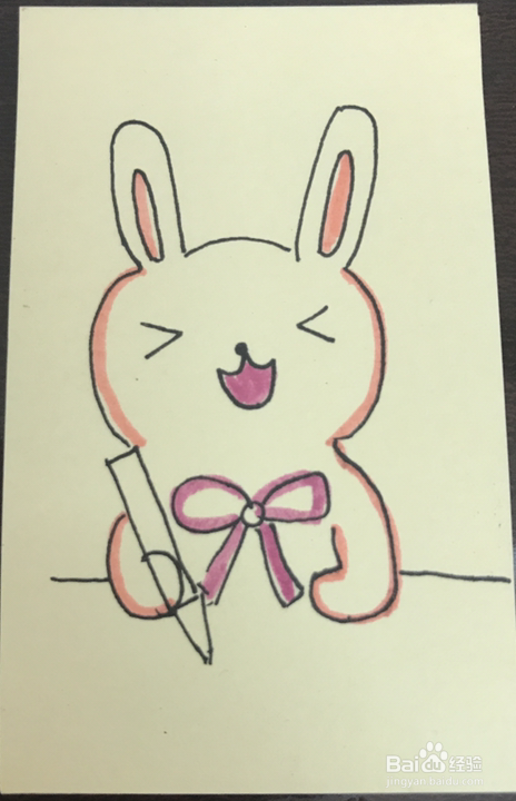 如何绘制一只拿着笔画画的兔子？