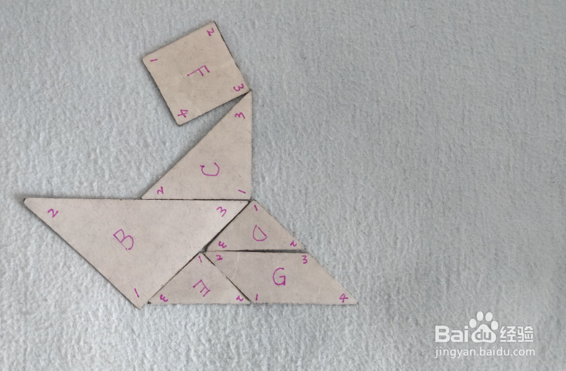 用七巧板怎样拼一个坐在船上沉思的人