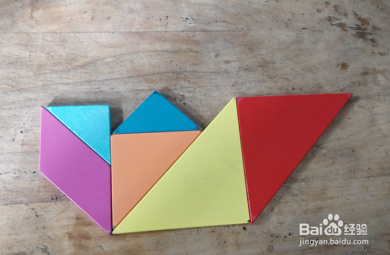 用七巧板怎样拼坐摇摇车的小孩儿