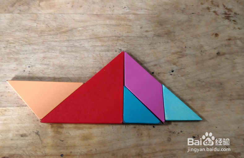 用七巧板怎样拼一个坐在船里的人