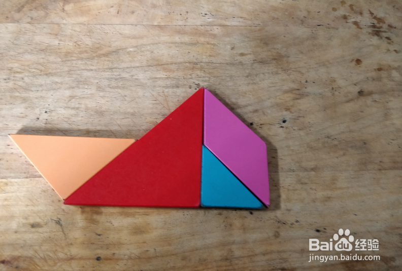 用七巧板怎样拼一个坐在船里的人