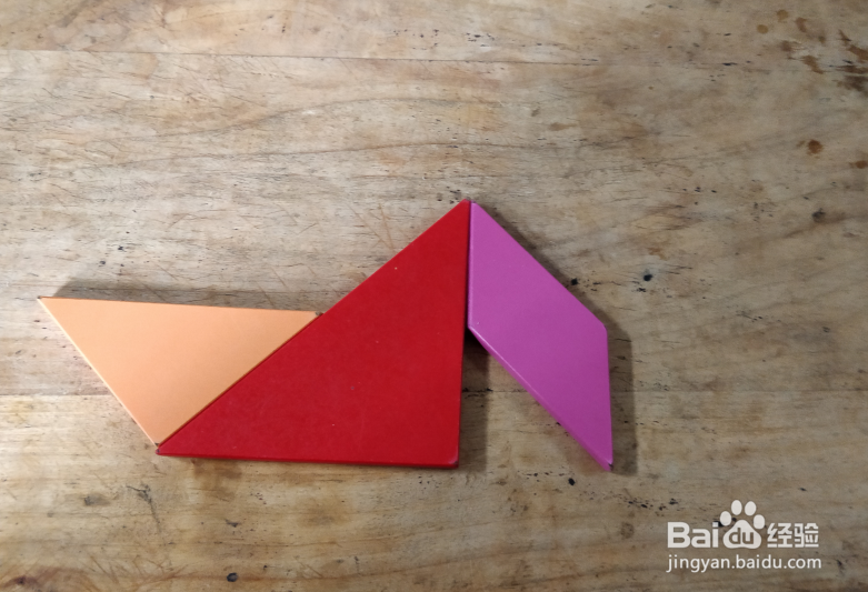 用七巧板怎样拼一个坐在船里的人